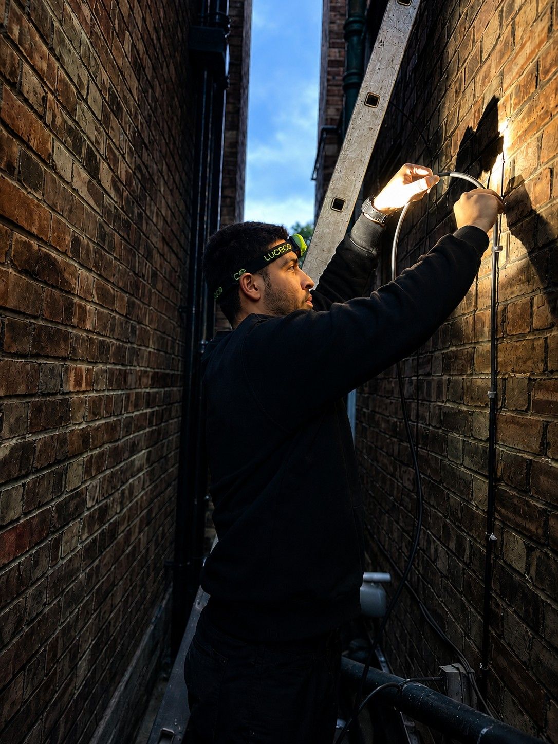 Emergency electrician carrying out outdoor electrical repairs in London