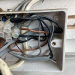 Junction box in Acton property showing earth conductors cut off at cable ends