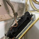Socket outlet back plate in Acton showing earth terminal with no earth wire connected