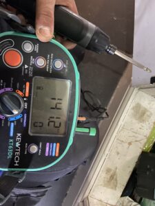 Electrician testing wiring during fault finding in Acton
