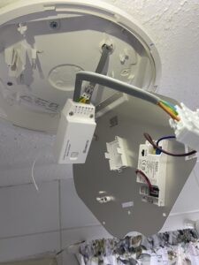 Wireless receiver fitted inside a bathroom light to replace a faulty switch line