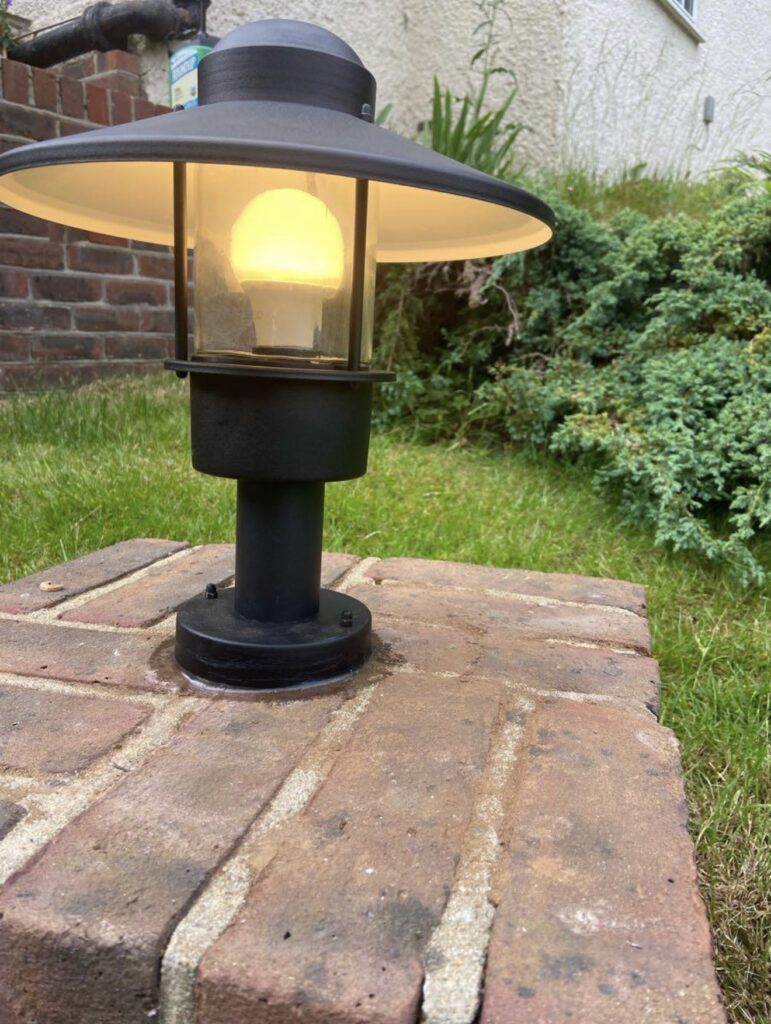 Outdoor garden post light installed on brick pillar in Acton