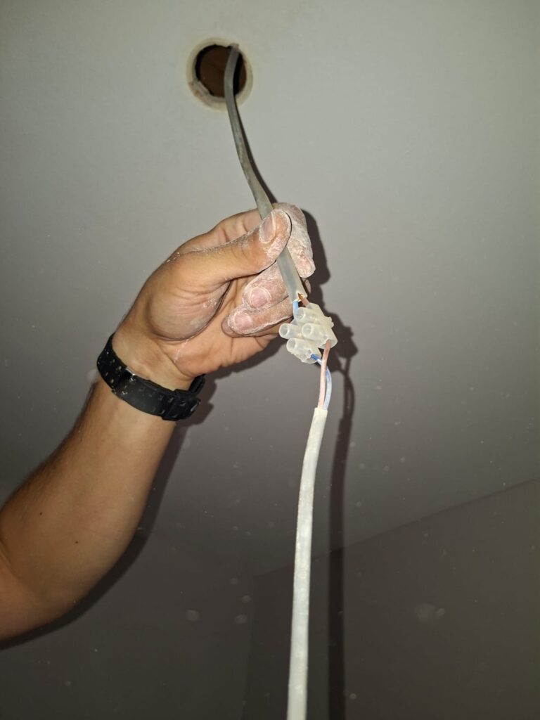 Downlight connection without enclosure or earth found during EICR in Chiswick