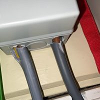 Damaged cable entry without protective cable gland on a shower consumer unit in London