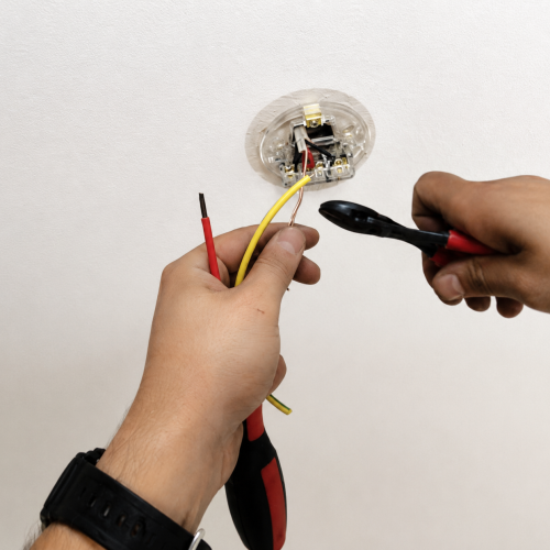 Electrician testing electrical fault with multimeter London