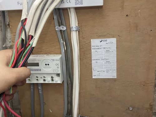 Electrician wiring a consumer unit, Kingston London
