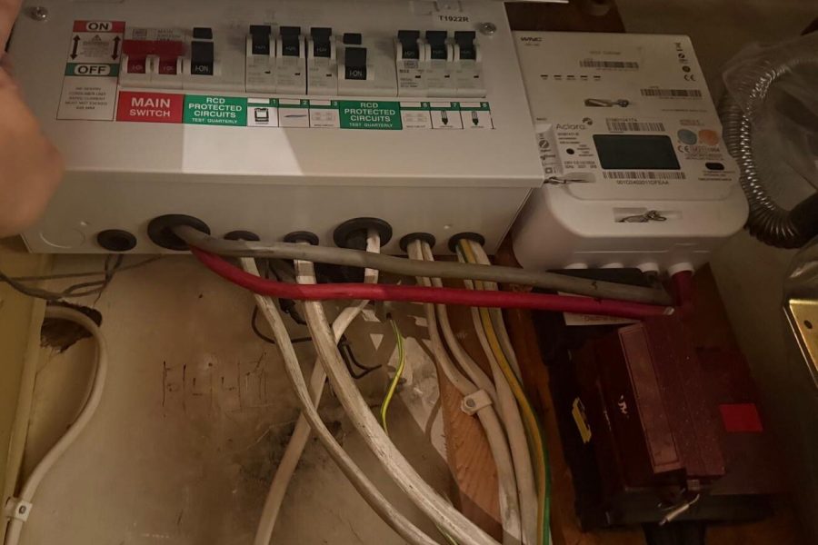 Electrician inspecting a consumer unit during an EICR in Chiswick