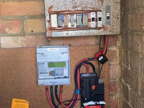 Before electrical services in London showing an outdated fuse board before replacement by a qualified electrician in London